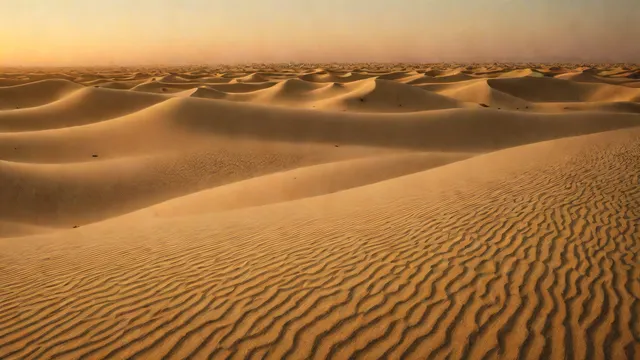 Desert landscape at dawn with textured sand and soft light